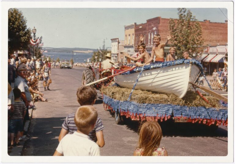 The Lake Days rowboat float from behind, the street running down to the lake, mid-1960s